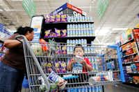 Bernarda Ortiz, 54, with her grandson Julian Ortiz, 3, shops for Takis corn chips at the Wal-Mart on Webb Chapel Road in northwest Dallas. Wal-Mart has changed its stores over the years by adding more Latino brands and Spanish signage to accommodate their Spanish-speaking customers. (Ben Torres/Special Contributor)