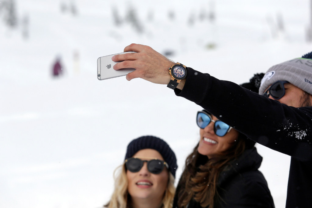 A group huddles together to take a selfie photo on a cell phone at the Paradise area at Mount Rainier Nati   onal Park, Wash. Spotty or no cellular service has been the norm at the nation's fifth oldest park south of Seattle.&nbsp;AP