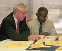 Dallas ISD trustee John Dodd and board President Hollis Brashear look over some of the statistics about the Dayton City Schools during a visit to Ohio in 1999.&nbsp;File photo/Staff