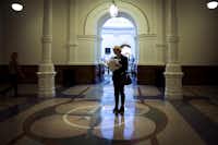 Christy Zartler  consults her notes for her next meeting while shuffling between meetings at the Texas state capitol on March 15, 2017, in Austin. (Smiley N. Pool/The Dallas Morning News)