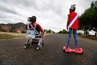Rickey Dixon, in his wheelchair, and his daughter Alana, who wore a beauty pageant crown and sash while on her hoverboard, ride through their neighborhood in Red Oak on Sunday, April 9, 2017. &nbsp;(Tom Fox/The Dallas Morning News)