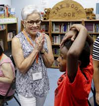 Connie Koehler, 65, a volunteer with Reading Partners, visits with Bradley Williams, 7, before their tutoring session at the Como Community Center in Fort Worth.&nbsp;(Ron Baselice/Staff Photographer)