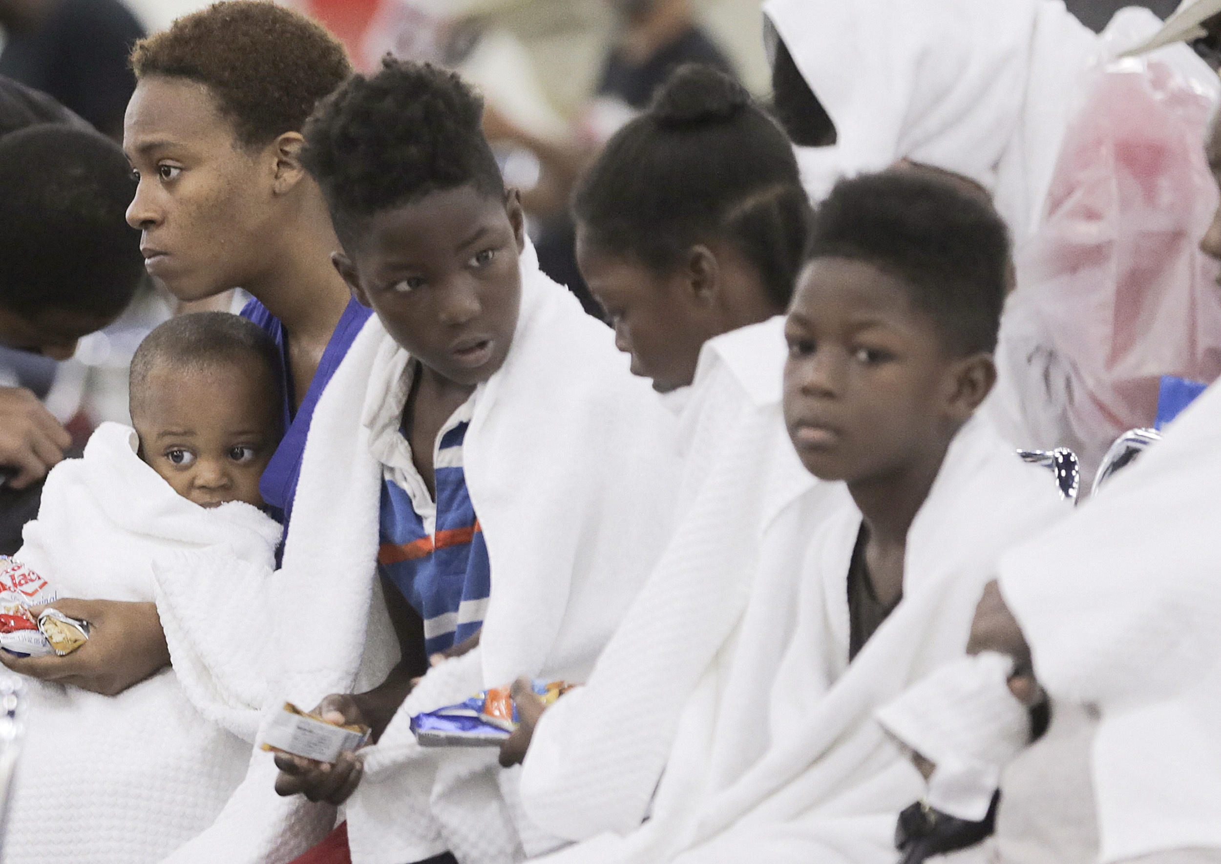 Terranysha Ferguson holds her son, Christian Phillips, as she sits Sunday with the rest of her family at the George R. Brown Convention Center in Houston.&nbsp;(Elizabeth Conley/Houston Chronicle)