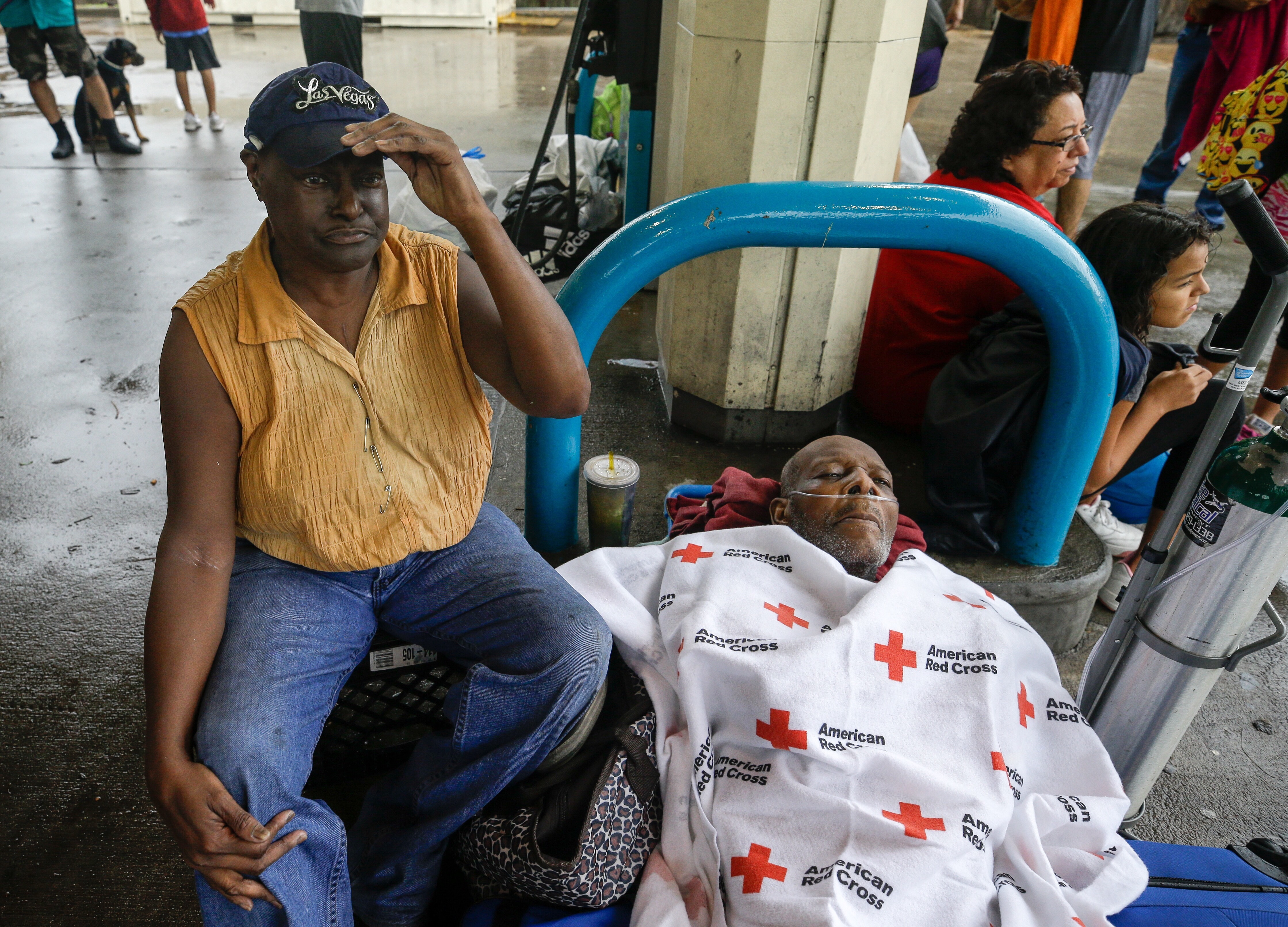 Ruby Young waits with her husband, Claude Young, after being rescued from their flooded home by boat Sunday and taken to a pickup point along Edgebrook Drive in Houston. Claude Young has health issues from a stroke in May.&nbsp;(Melissa Phillip/Houston Chronicle)