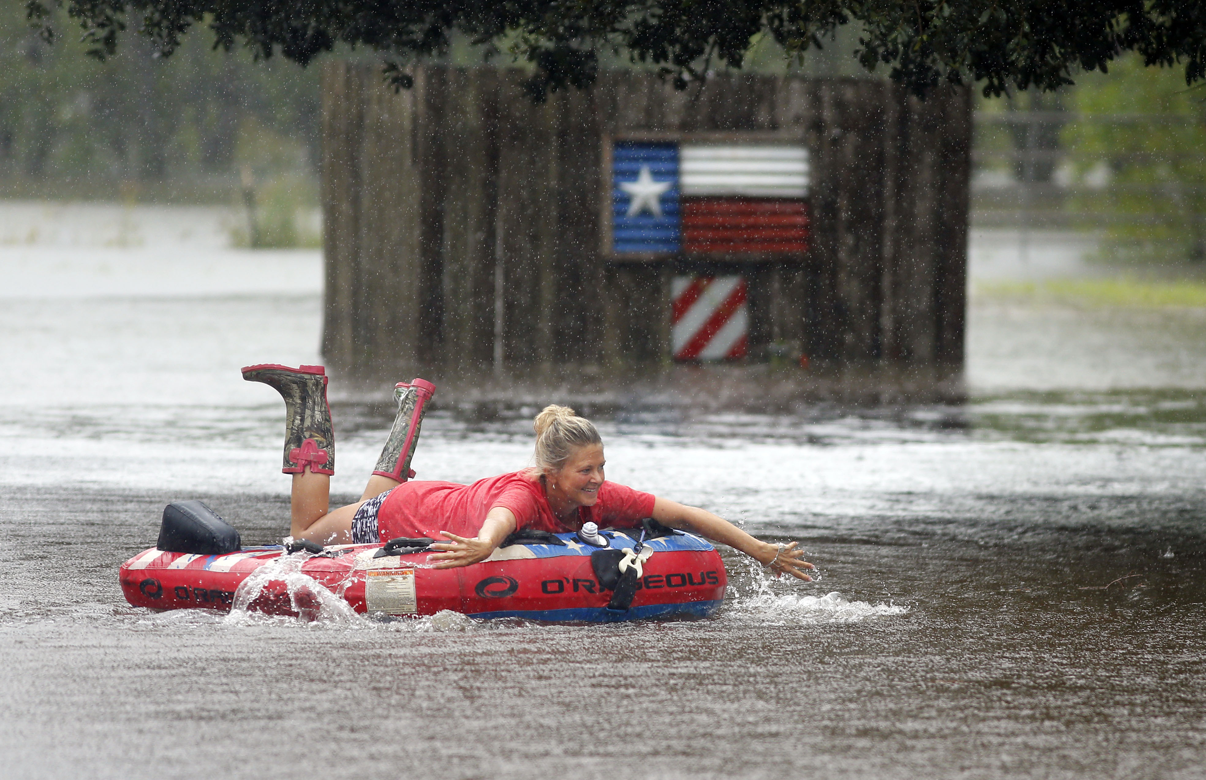 Loretta Ward plays during a downpour Sunday at her flooded ranch along Pearland Sites Road in Pearland. Tropical Storm Harvey dumped waves of rain along the southeast Texas coast and the Houston area.&nbsp;(Tom Fox/Staff Photographer)