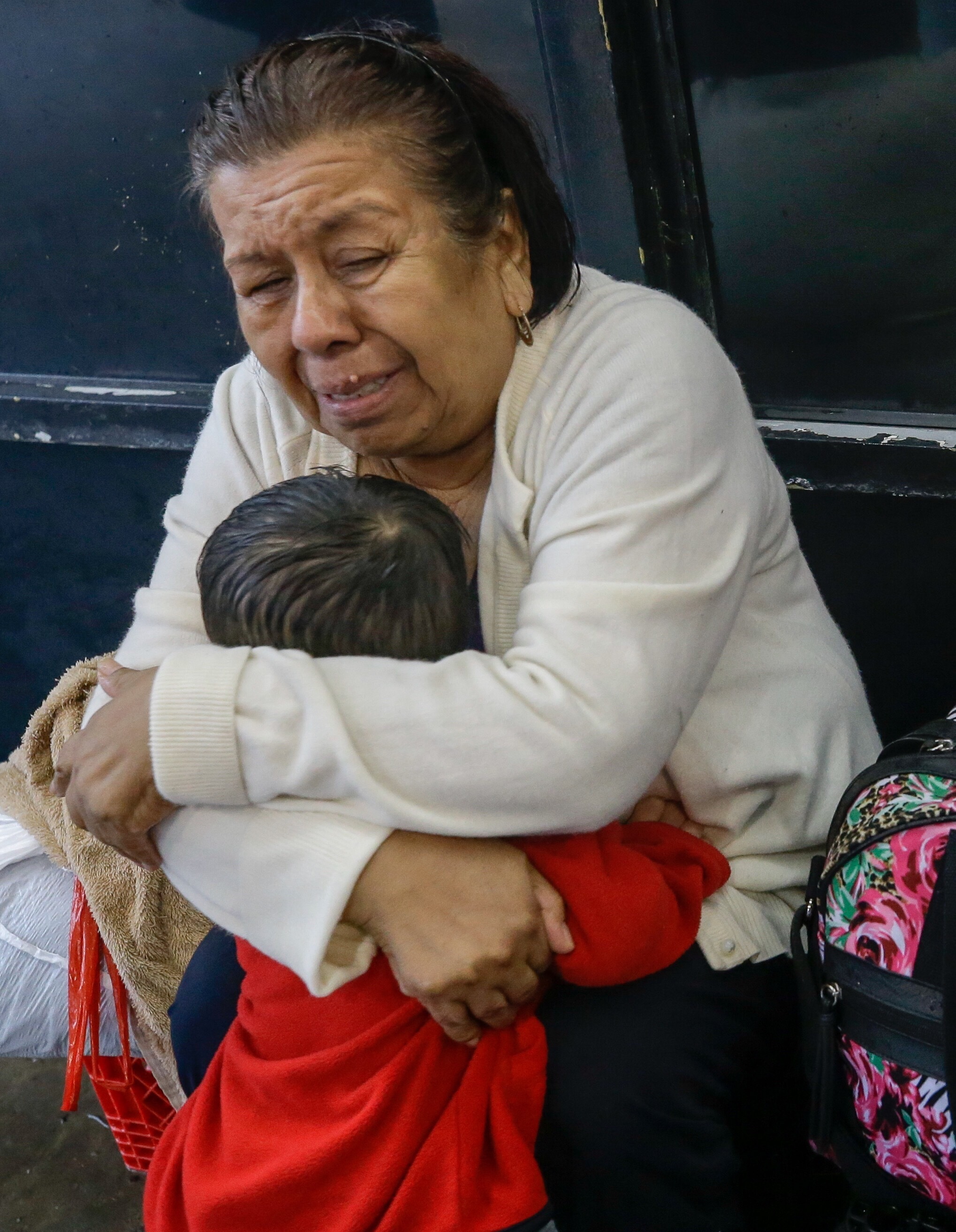 Neri Sanchez cries as she hugs her grandson, Jonathan Sanchez, 1, after being reunited at a rescue boat pickup area Sunday along Edgebrook Drive in Houston.&nbsp;(Melissa Phillip/Houston Chronicle)