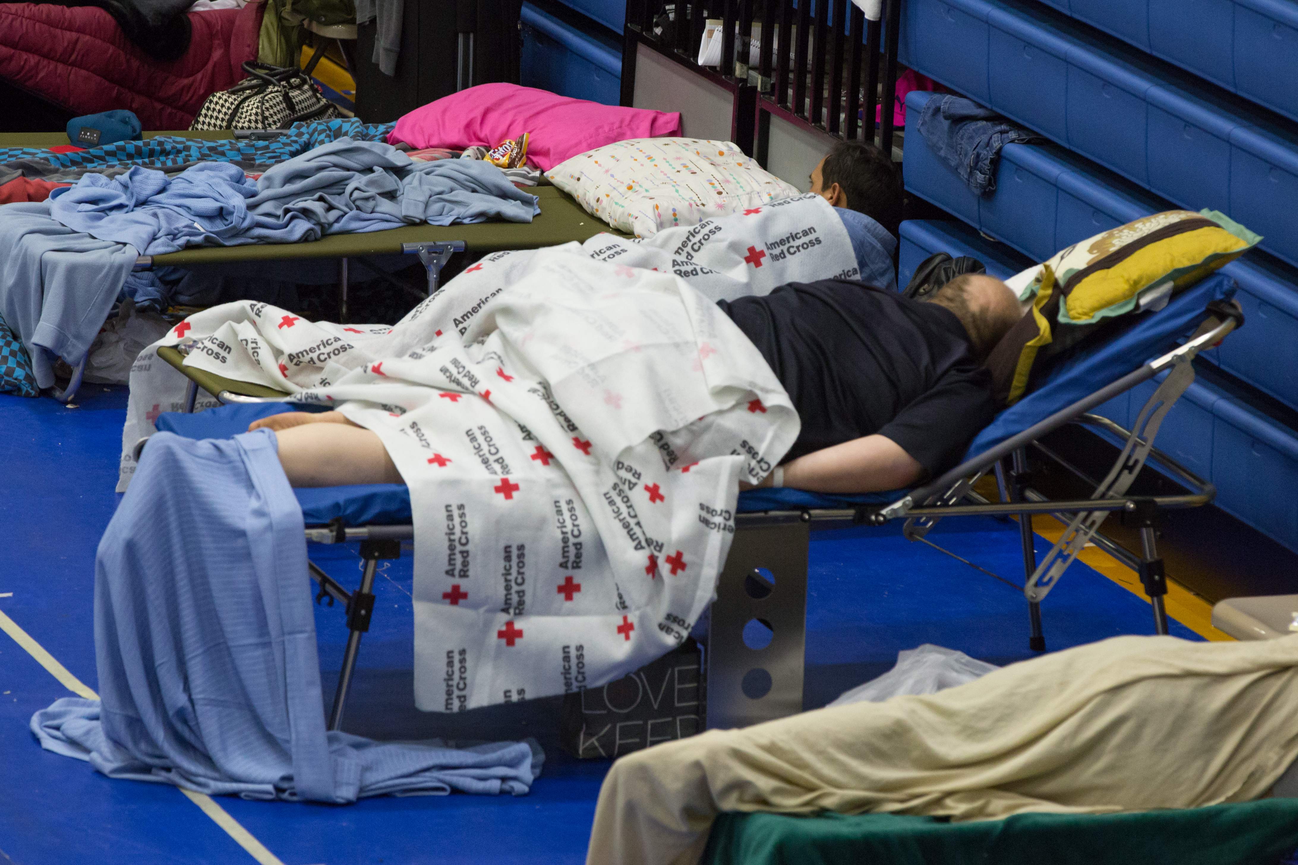 Evacuees from Hurricane Harvey take shelter at the Delco Center in east Austin, Texas on Sunday, August 27, 2017. The Red Cross says they currently have 185 people but if needed, are prepared to handle 350 people at this location.&nbsp;(SUZANNE CORDEIRO/AFP/Getty Images)