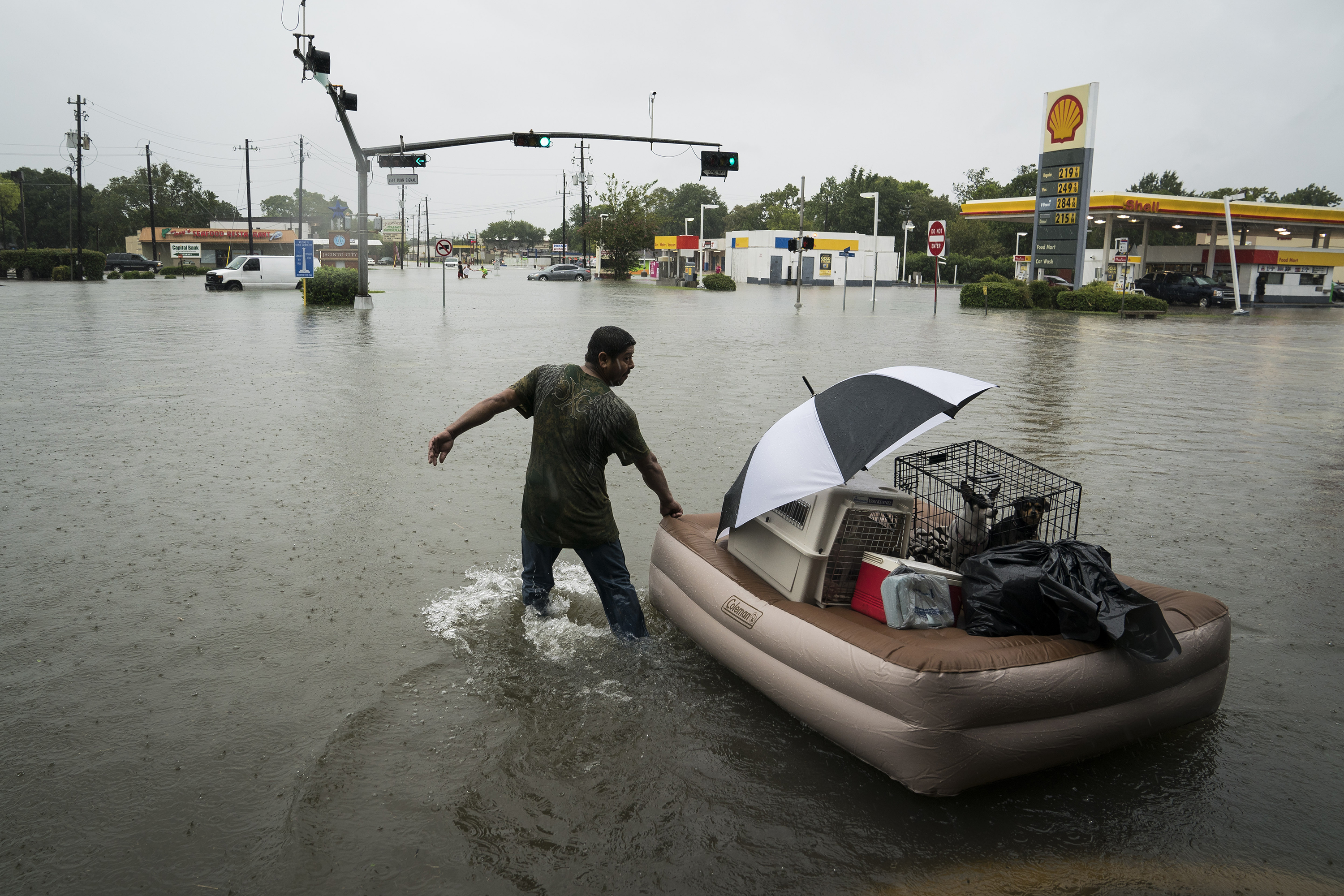 <p><span style="font-size: 1em; background-color: transparent;">A resident floats his pets and belongings on an air mattress along Mercury Drive as he flees floodwater at his home in Houston on Sunday.</span></p>(Jabin Botsford/The Washington Post)