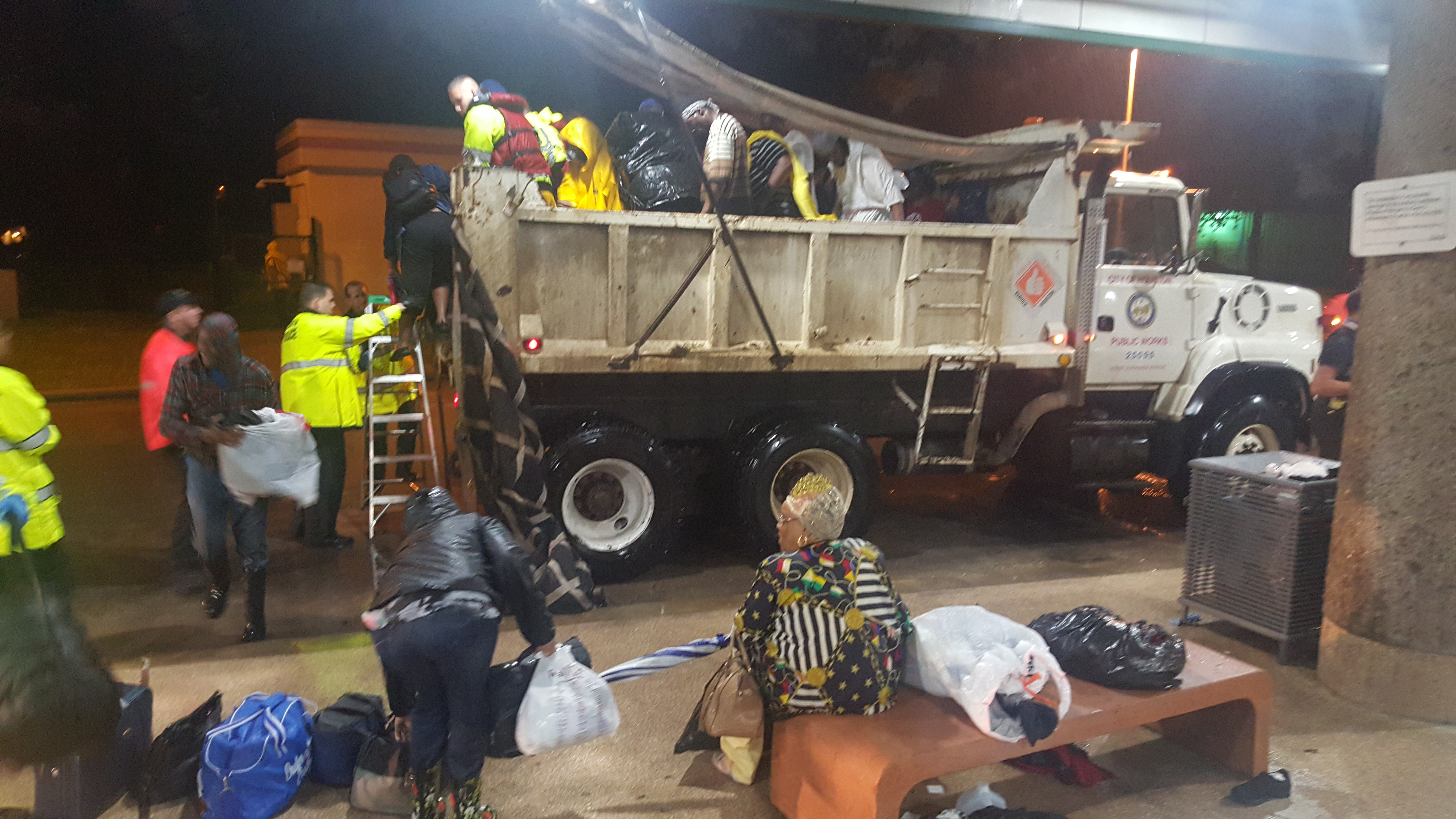 A dump truck pulls into Houston's Kashmere Transit Center with people rescued from Hurricane Harvey around midnight Monday