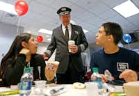 Capt. Jim Dees, Director of Flight with American Airlines, center, talks with Diana Lopez, 16, left, and Alfonso Apodaca, 15, teenage amputee patients from Scottish Rite Hospital, during a ceremony at Dallas-Fort Worth International Airport in DFW Airport, Monday, Feb. 12, 2018.(Jae S. Lee/Staff Photographer)