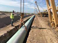 A shortage of crude oil and natural gas pipeline capacity is squeezing Permian Basin drillers. Kinder Morgan's $1.75 billion Gulf Coast Express natural gas pipeline -- seen here in June 2018 in Midland County -- is under construction and will link the Permian Basin with the Texas Gulf Coast. Despite President Donald Trump's new steel tariffs, that project and others in the Permian Basin are still going forward.(Kinder Morgan/&nbsp;)
