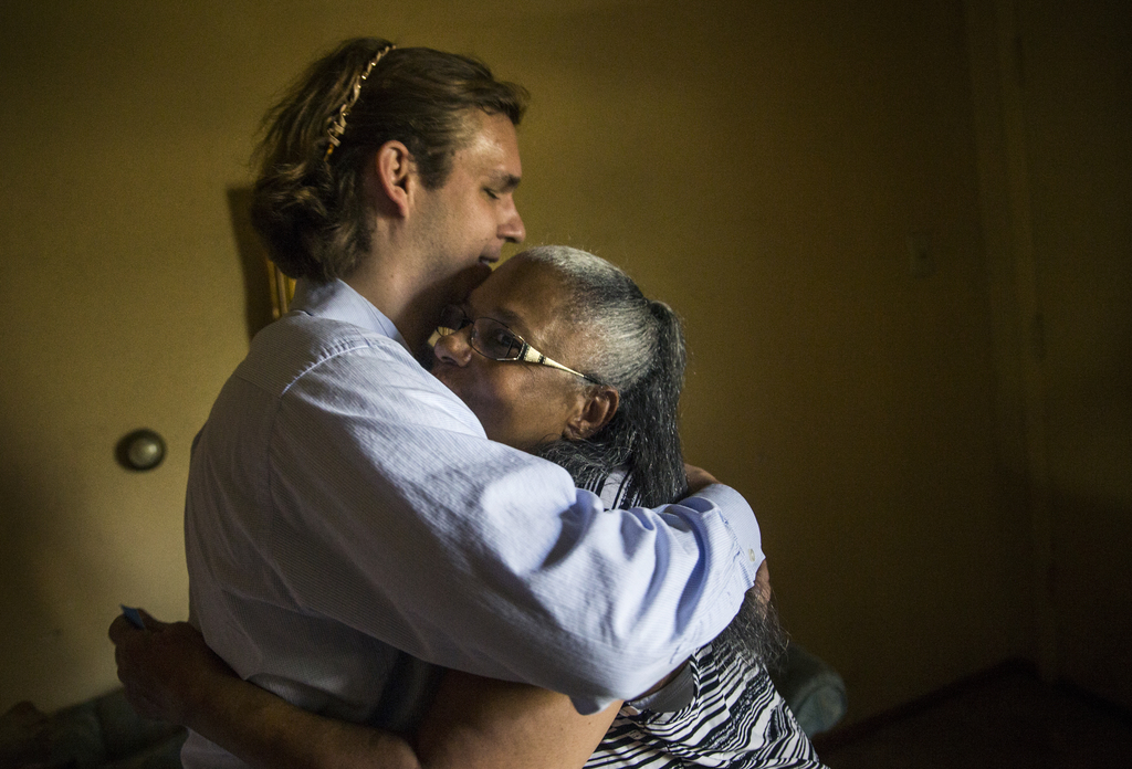 Belinda Darden embraces tax consultant Will Toler at her Hamilton Park home Monday in Dallas.&nbsp;(Ryan Michalesko/Staff Photographer)