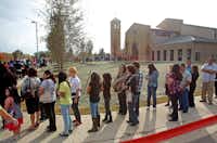 A long line wound around St. Cecilia Catholic Church before the start of 3 p.m. Mass for the dedication of the new building  on Nov. 20, 2011. (Louis DeLuca/Staff Photographer)