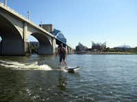 The Onean Carver electric surfboard, among cutting-edge gear available for rent from Adventure Sports Innovation in Chattanooga, lets you surf up to 25 mph, without waves, on the Tennessee River as it runs through downtown. (Robin Soslow/Special Contributor)