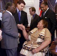 Then-Texas Gov. Rick Perry, second from left, shakes the hand of Stella Byrd, mother of James Byrd Jr., the East Texas black man who was dragged to his death from a pickup truck in 1998 by three white men, following the signing of the James Byrd Jr. Hate Crimes Act at the Capitol in Austin, Texas, in May 2001. Gov. Perry signed the bill into law which strengthens the penalties for offenses against minorities, gays and others.&nbsp;(File Photo/The Associated Press)